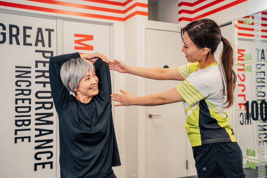 A specialist guiding a simple self-stretch to do at home